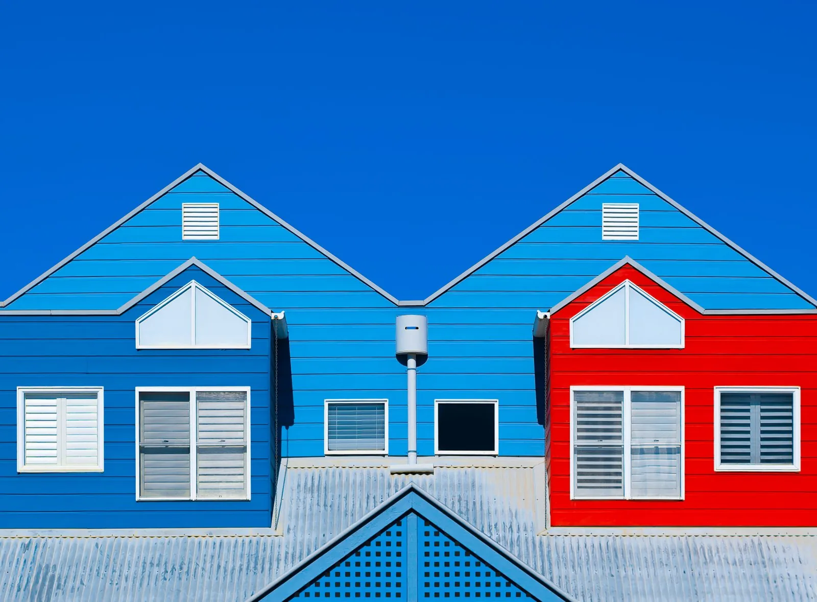 Best exterior paint colors 2026 on bright blue and red house facades