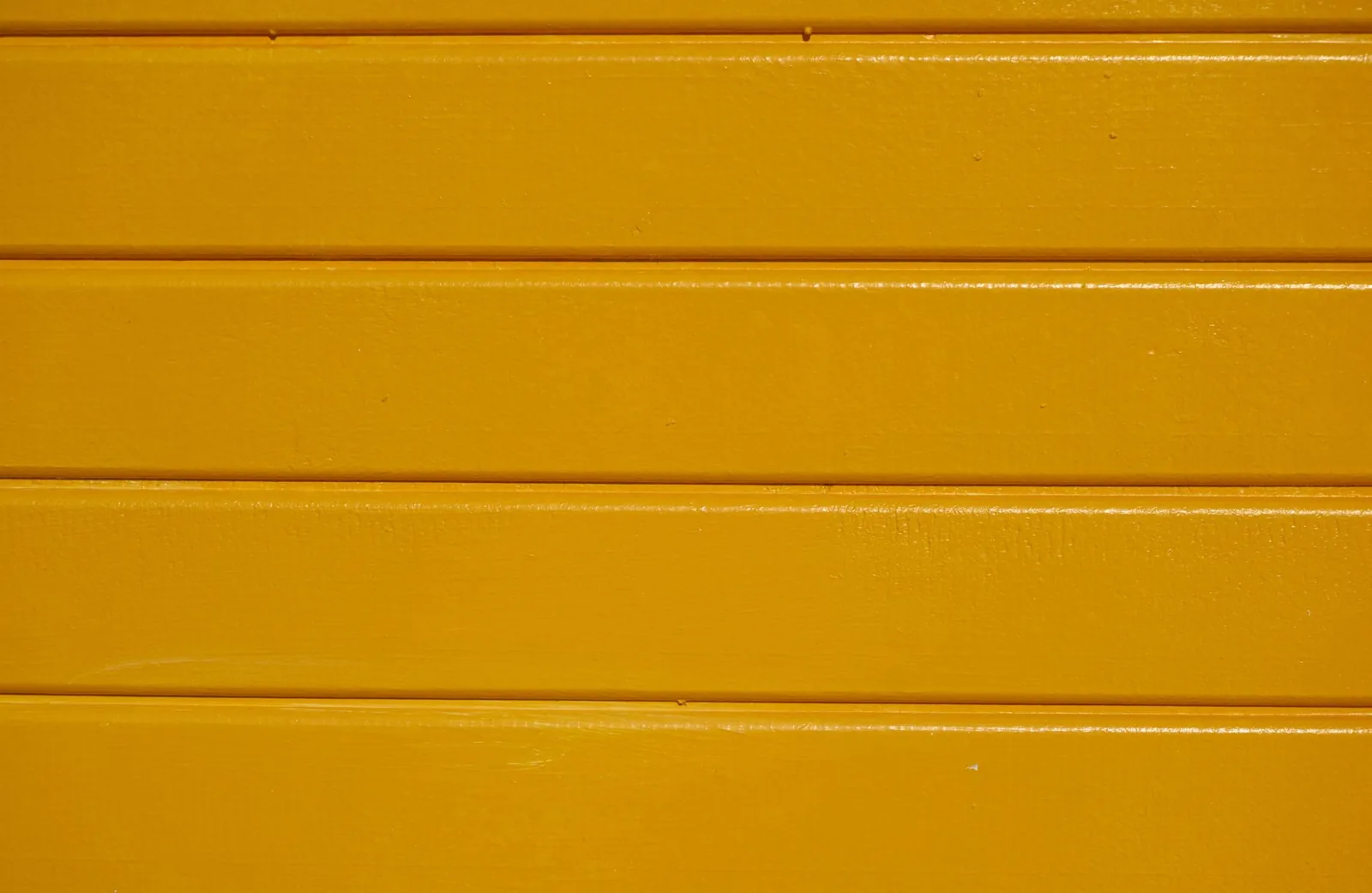 Painted fiber cement planks in a warm yellow finish
