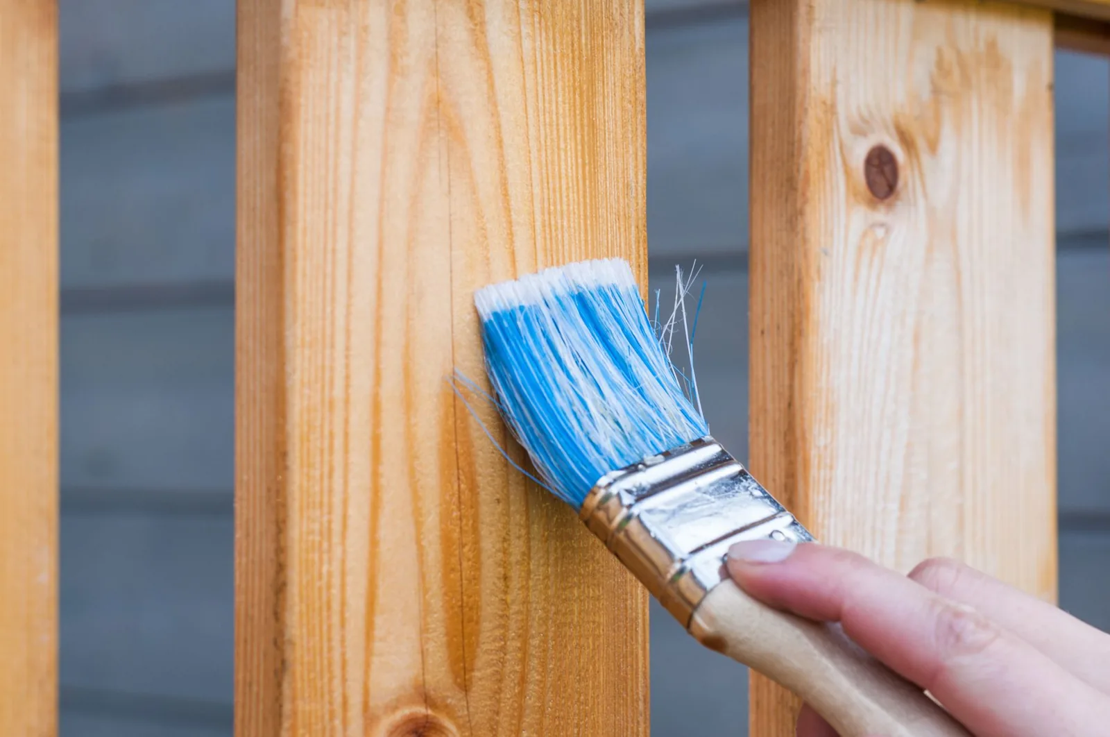 calculating exterior paint cost per square foot while painting a wooden fence