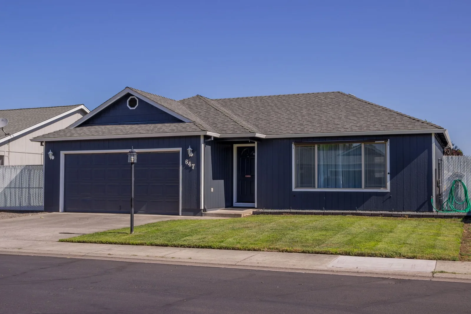 Charming suburban house with driveway, garage, and well-maintained lawn
