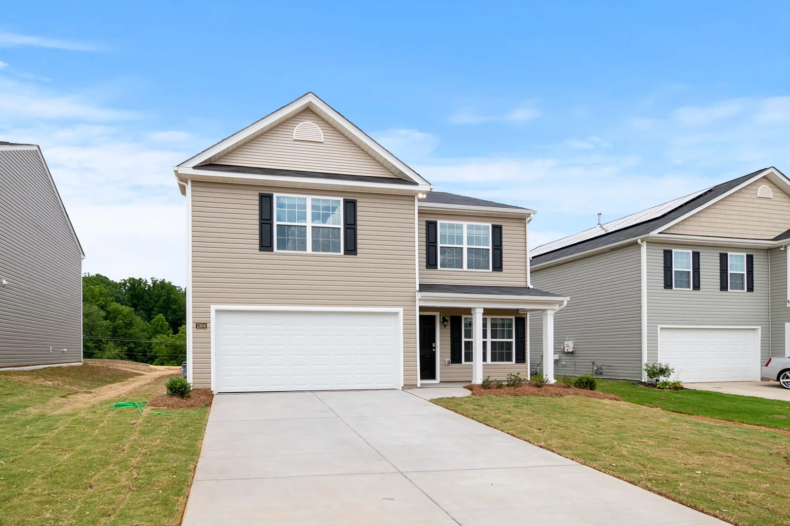 Contemporary two-story suburban home showing a two-tone painted exterior with contrasting trim
