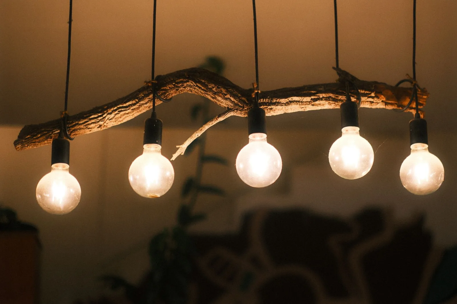 Warm string lights and layered accent lighting across a home's exterior