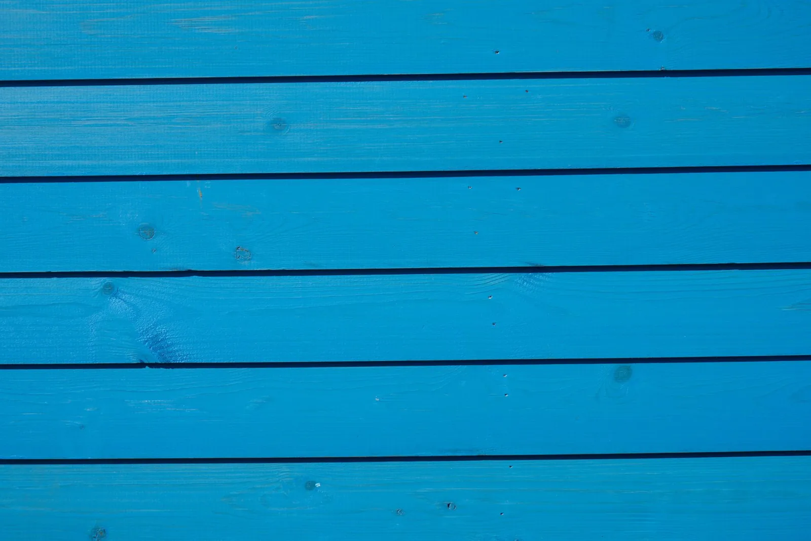 Vibrant blue wooden paneling with a detailed texture