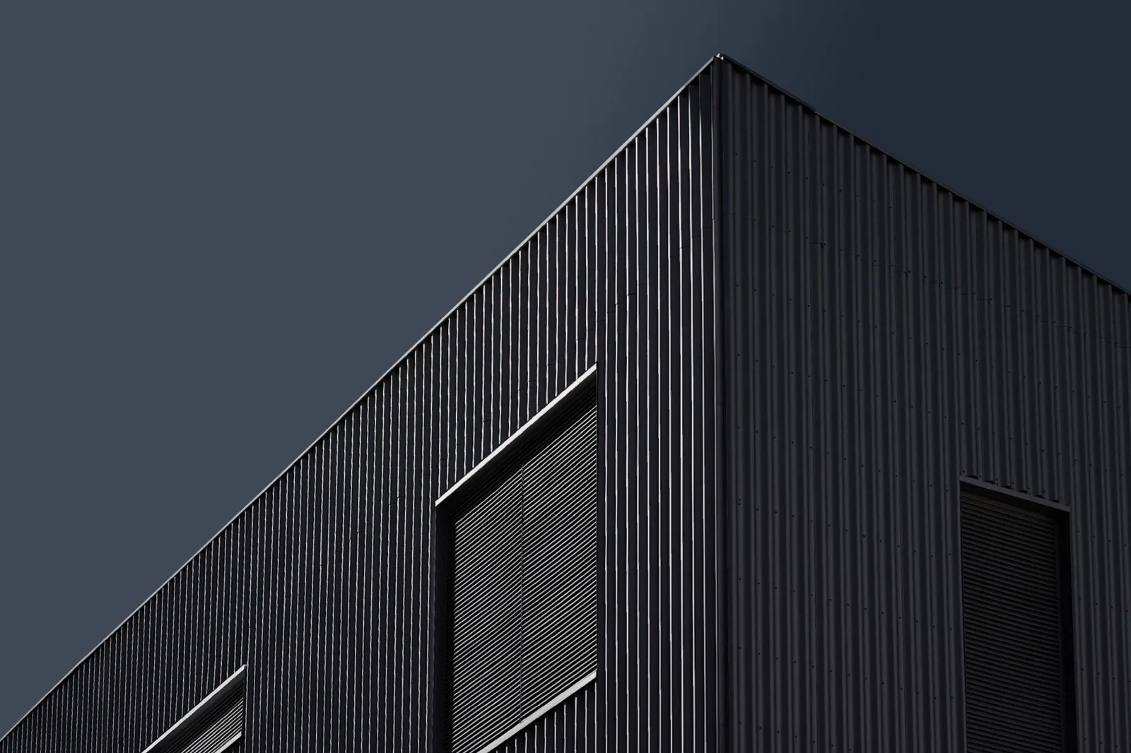Modern house facade with dark geometric cladding
